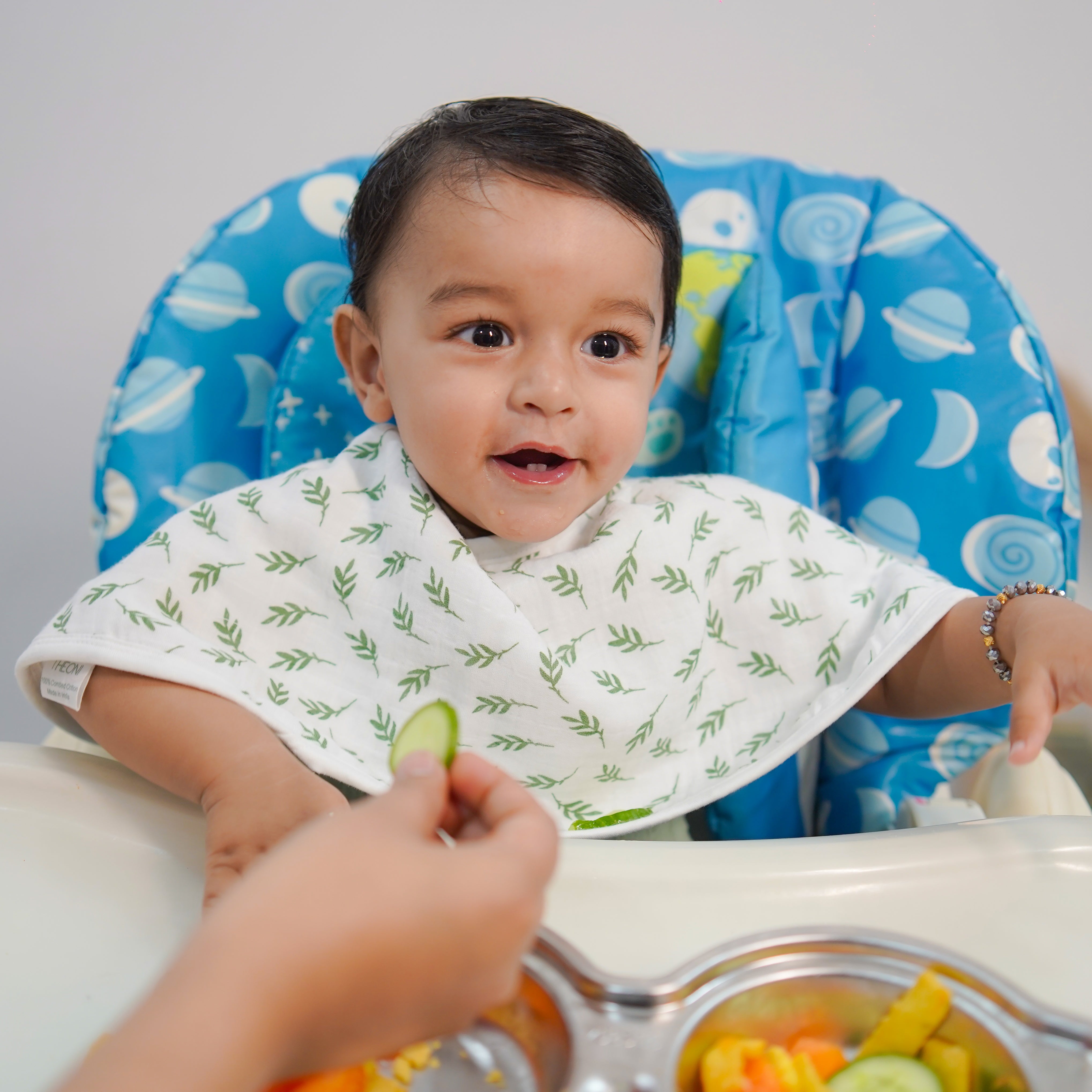 Green_hedge_baby_eating_burpy_cloth